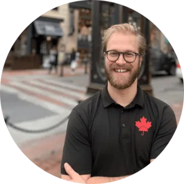 A man in a black shirt with a canadian flag on his shirt.