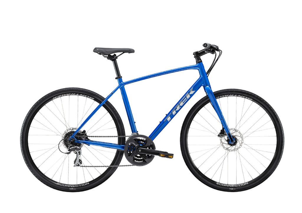 A blue Trek bicycle with a lightweight frame, flat handlebars, disc brakes, and thin tires designed for road and light trail use.